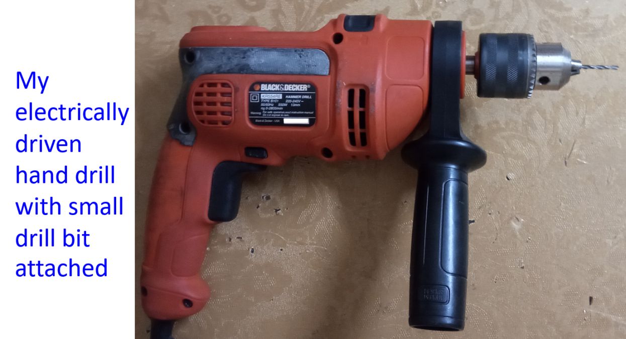 My electrically driven hand drill with small drill bit attached